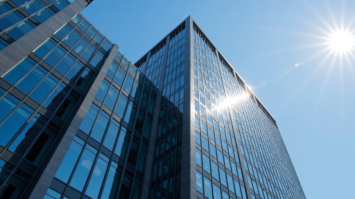 Modern office building exterior, glass curtain wall architecture, sunlight shining, commercial area environment, daytime shot